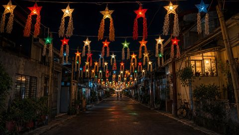 The Parol: a street strung with paper star lanterns in red, green and gold