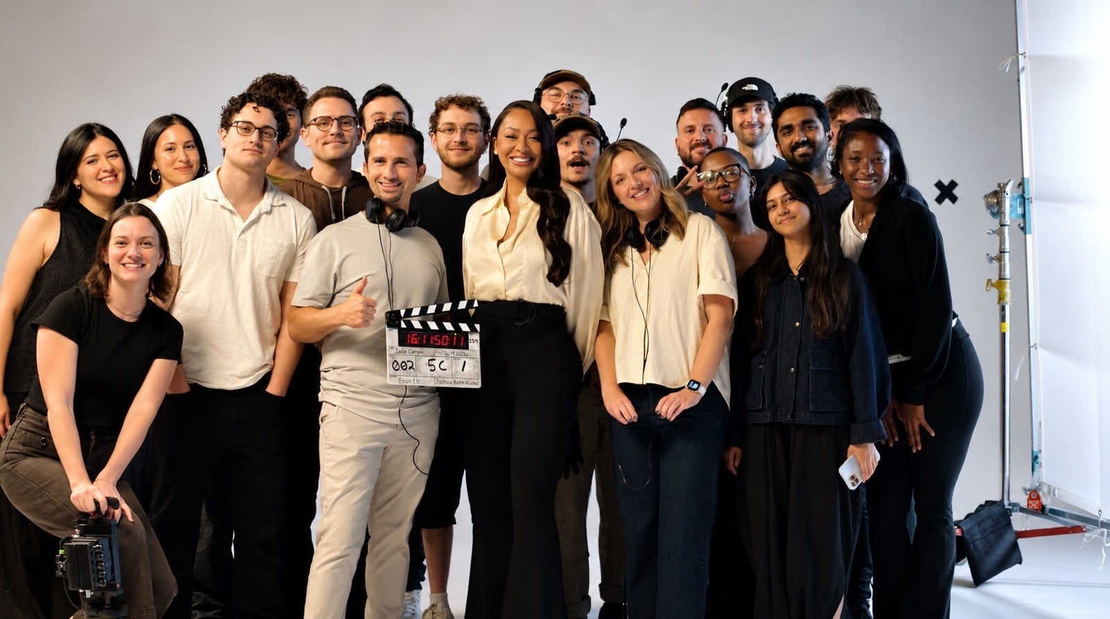 La La Anthony and the crew on a white cyc, clapper raised, mid-shoot